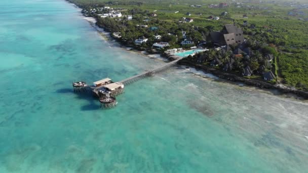 Beautiful thatch stilt house at Zanzibar Nungwi beach at evening time with blue Indian ocean aerial view — Stock Video