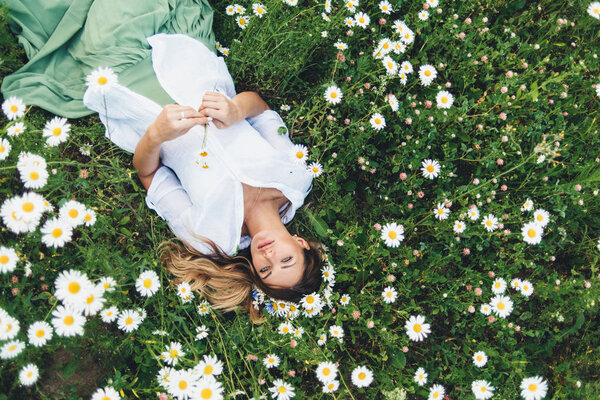 A girl in a field of chamomiles