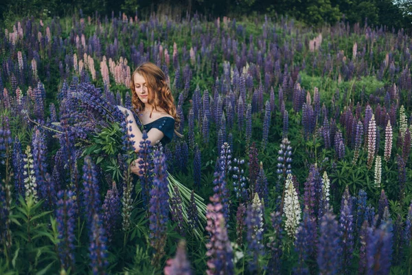 Girl with lupines — Stock Photo, Image