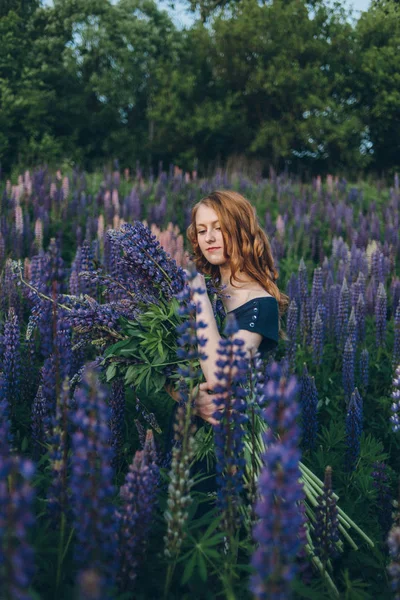 Girl with lupines — Stock Photo, Image