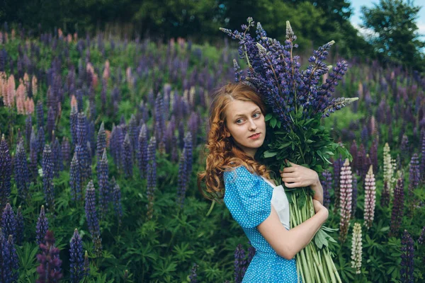 Girl with lupines — Stock Photo, Image