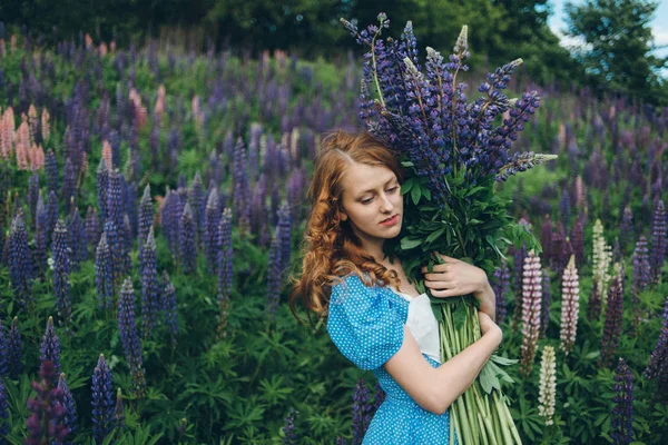 Girl with lupines — Stock Photo, Image