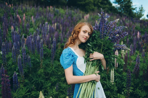 Girl with lupines — Stock Photo, Image