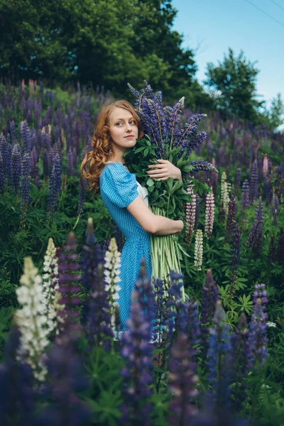 Girl with lupines — Stock Photo, Image