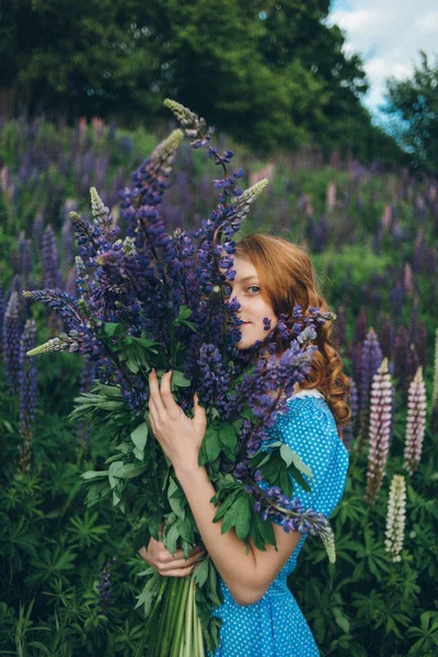 Girl with lupines — Stock Photo, Image