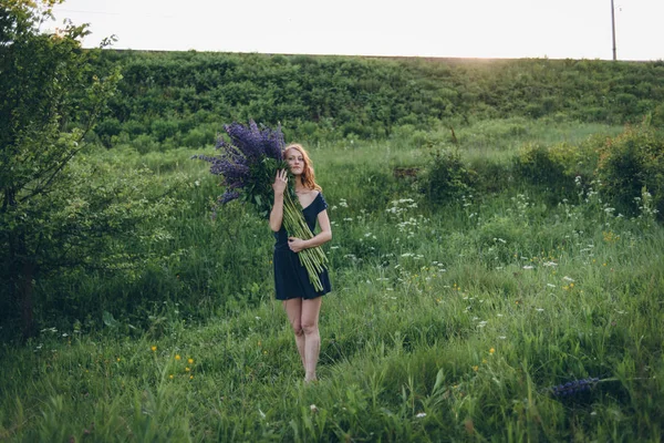 Girl with lupines — Stock Photo, Image