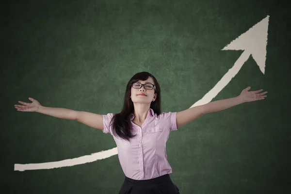 Beautiful woman raised hand with upward arrow — Stock Photo, Image