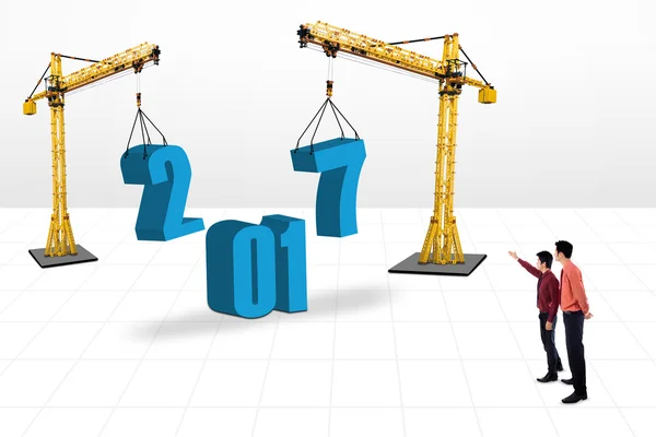 Businessman showing number 2017 with cranes — Stock Photo, Image