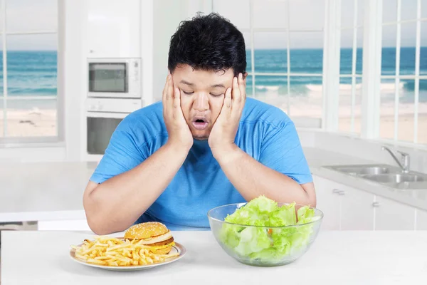 Asian person choosing salad or burger — Stock Photo, Image