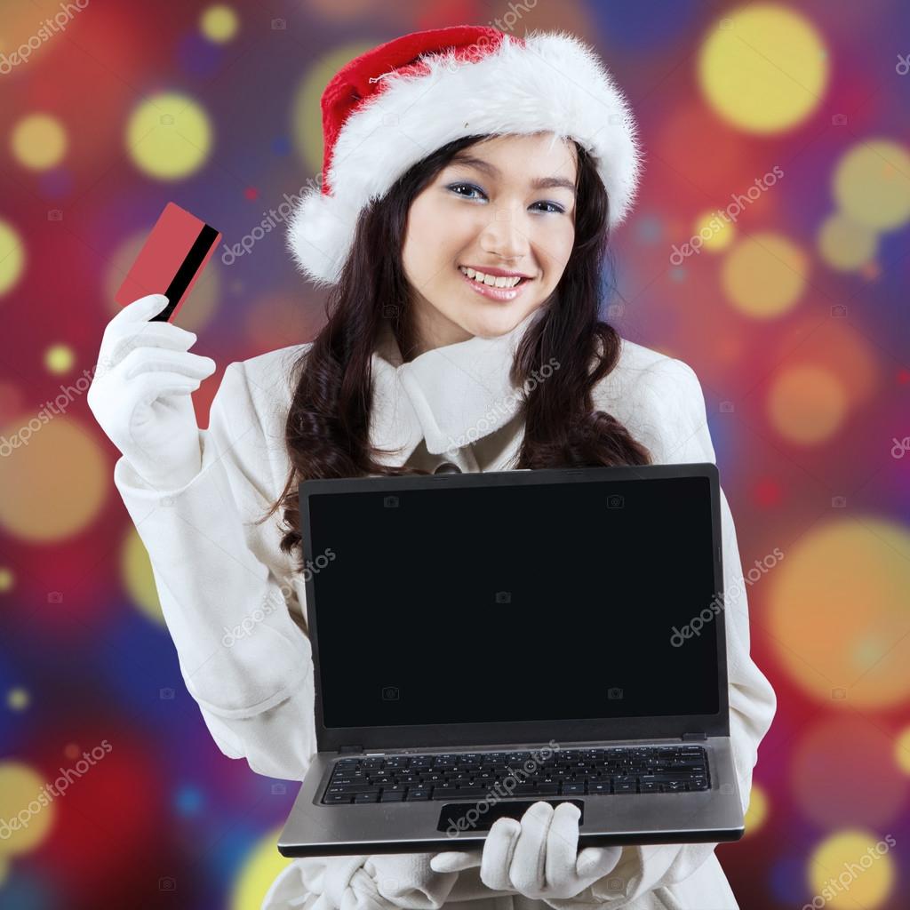 Pretty lady online shopping for christmas Stock Photo by ©realinemedia
