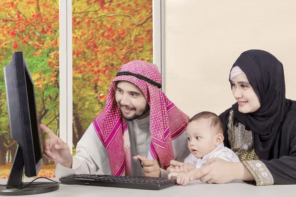 Arab family looking at the computer