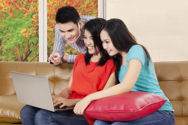 Young people enjoying holiday in the couch — Stock Photo, Image