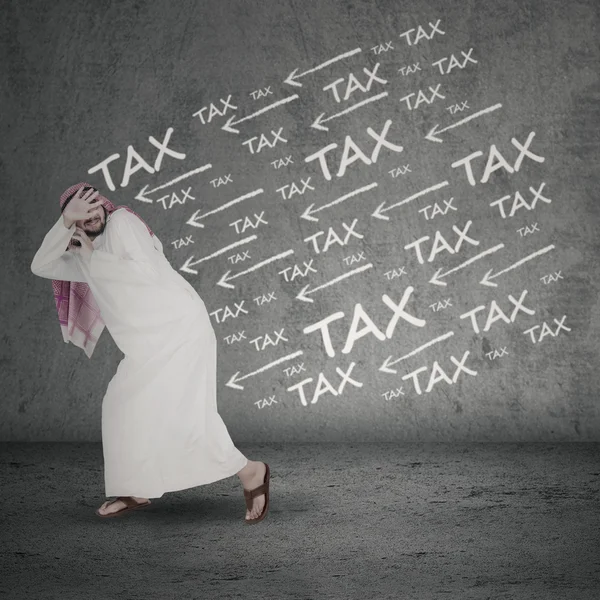 Arabian businessman running away from tax — Stock Photo, Image