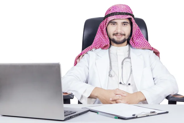 Confident Arabian doctor with laptop on desk — Stock Photo, Image