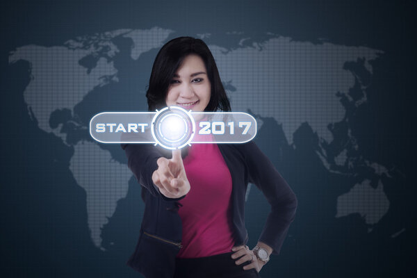 Asian woman touching start icon with 2017
