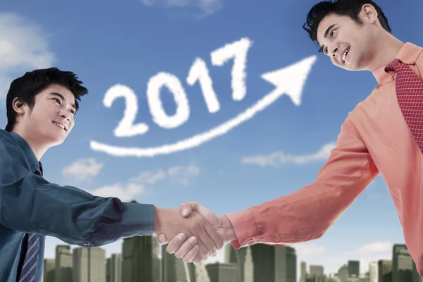 Business handshake with 2017