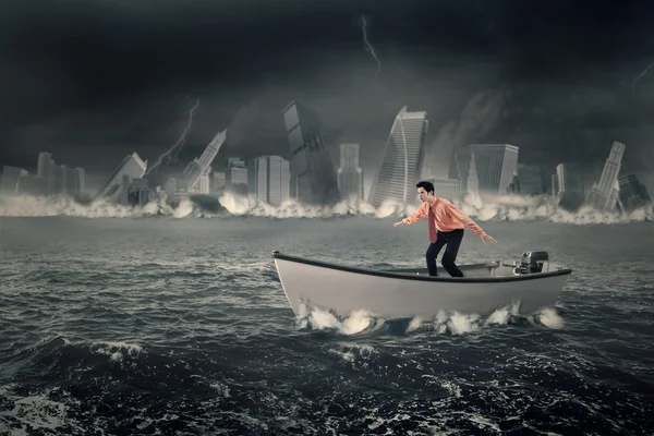 Businessman balancing on the boat — Stock Photo, Image