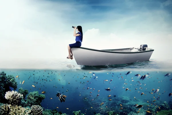 Female entrepreneur with binoculars on boat — Stockfoto