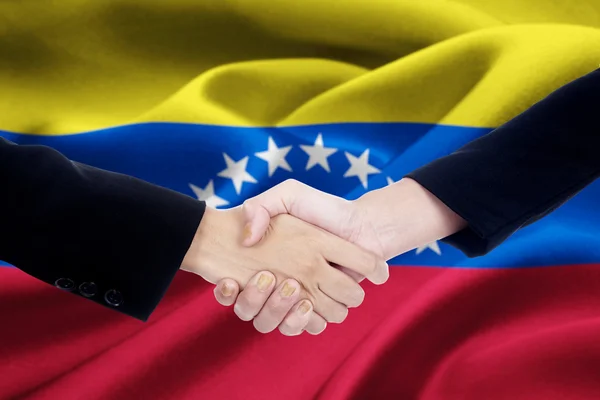 Flag of Venezuela with dealing handshake — Stock fotografie