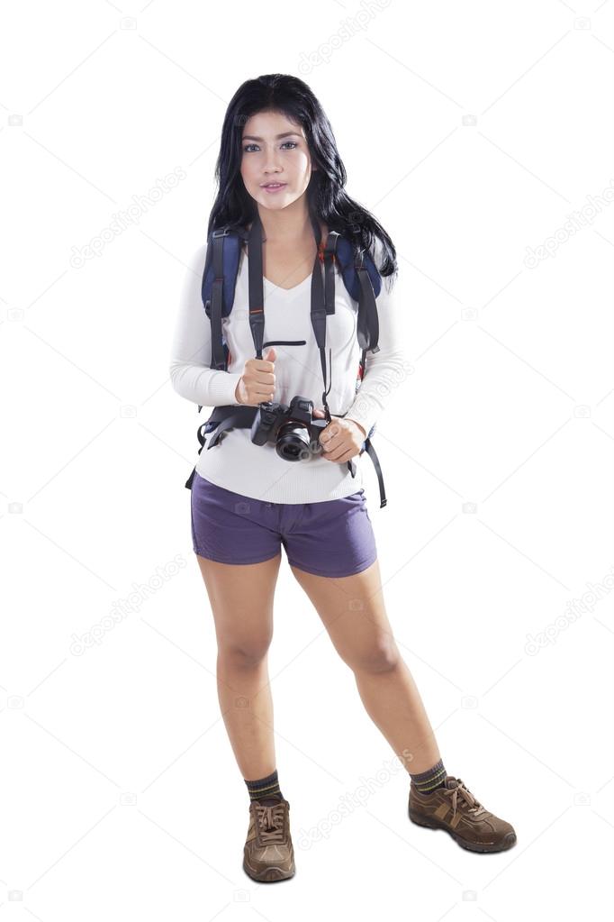 Woman hiker with backpack and camera