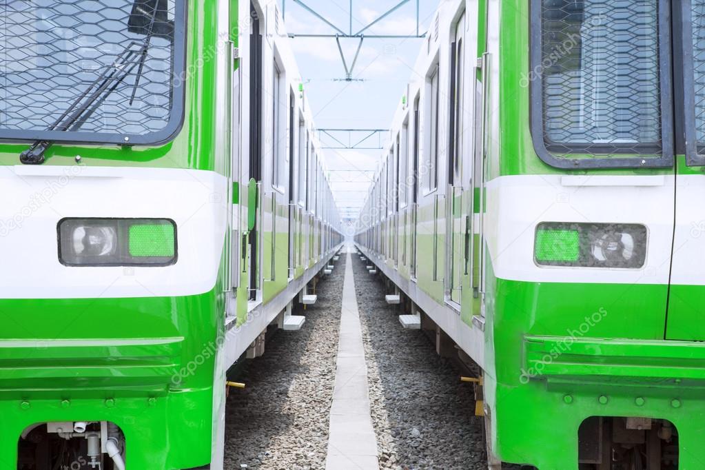 Two green electric trains