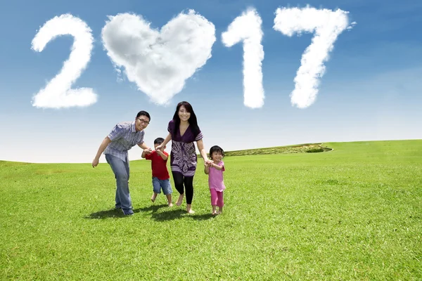 Family with cloud 2017 at field — Stock Photo, Image