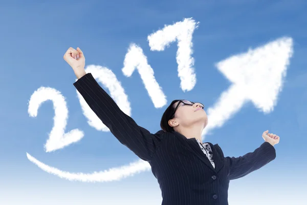 Woman outstretched hands under arrow and 2017 — Stock Photo, Image