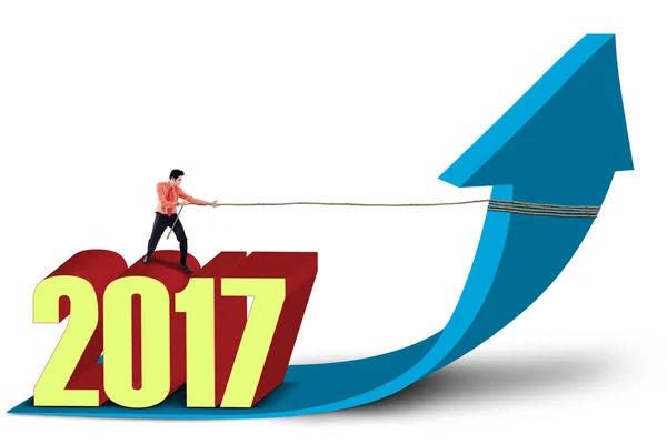 Businessman and numbers 2017 pulls upward arrow — Stock Photo, Image