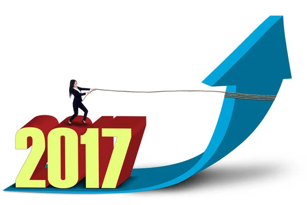 Entrepreneur and numbers 2017 pulling arrow upward — Stock Photo, Image