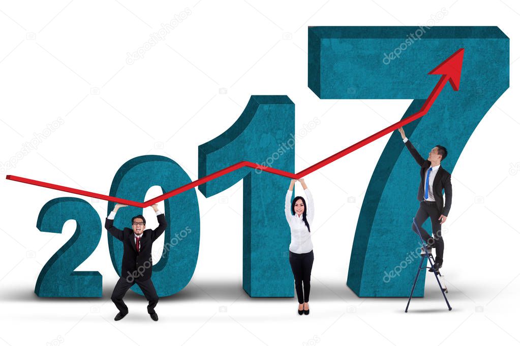 Business team holding graph with numbers 2017