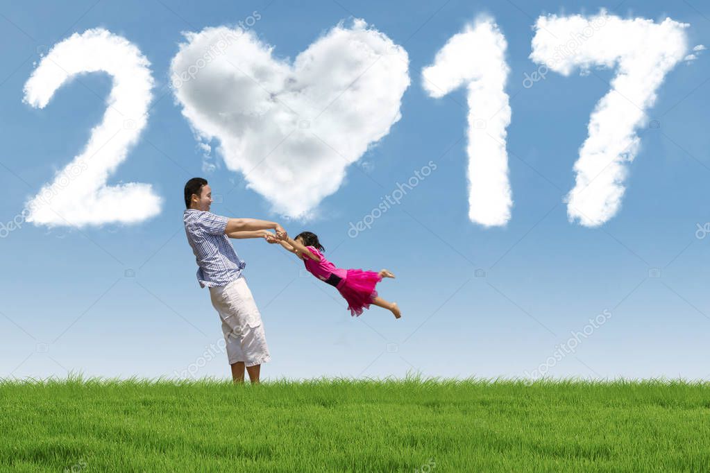 Man and daughter at field with 2017