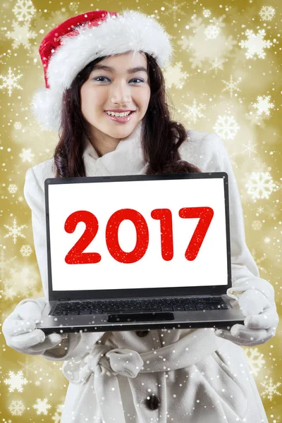 Vackra teenage visar antal 2017 på laptop — Stockfoto