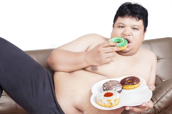 Fat man eating donuts — Stock Photo, Image