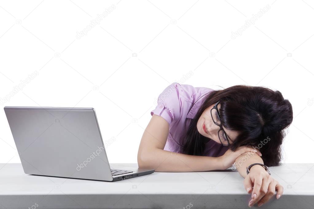 Woman sleeping with laptop in the workplace