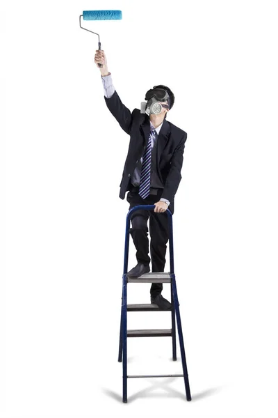 Empresario en escalera con rodillo de pintura — Foto de Stock