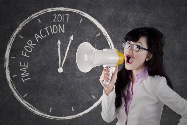 Businesswoman shouting with megaphone in the office — Stock Photo, Image