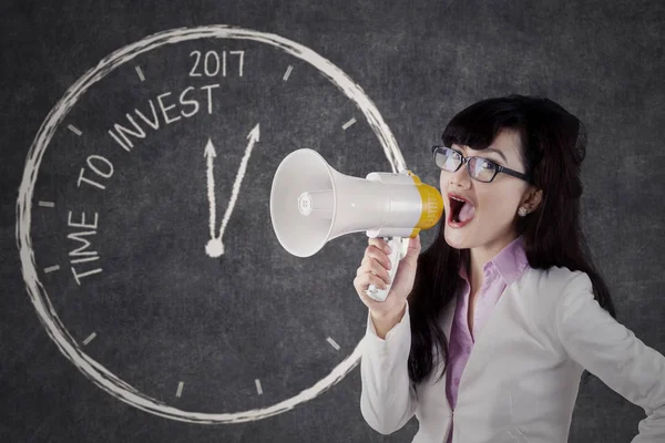 Businesswoman with megaphone and image of clock — Stock Photo, Image