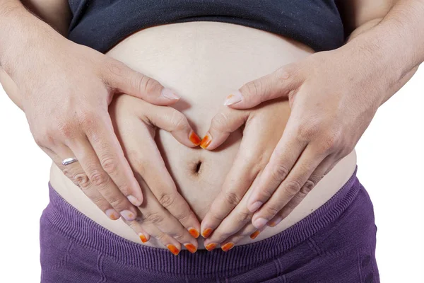 妊娠中のおなかと心のシンボル — ストック写真