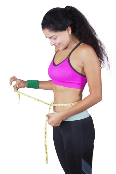 Woman measuring waist with tape — Stock Photo, Image