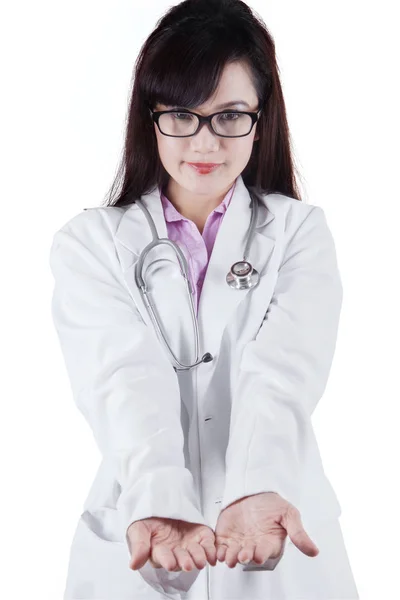 Young doctor showing something in her hands — Stock Photo, Image