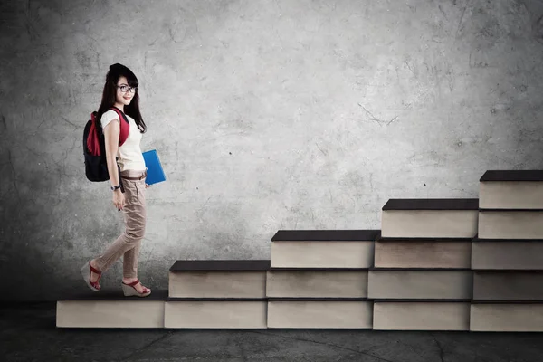 Estudante bonita andando nas escadas livros — Fotografia de Stock