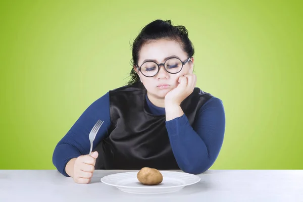 Fat woman feeling bored with potato — Stock Photo, Image