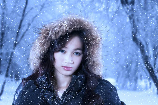 Красивая девушка в зимней одежде смотрит в камеру — стоковое фото