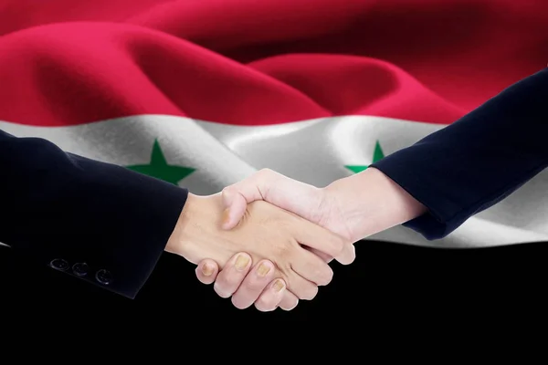 Poignée de main de négociation avec le drapeau de la Syrie — Photo