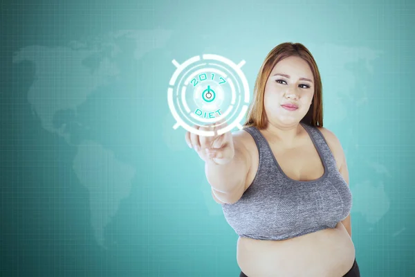 Obese woman click start button with 2017