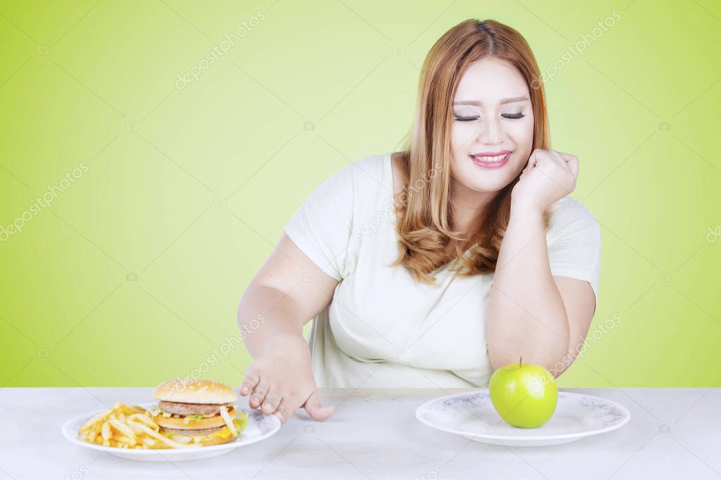 Blonde hair woman choosing apple 