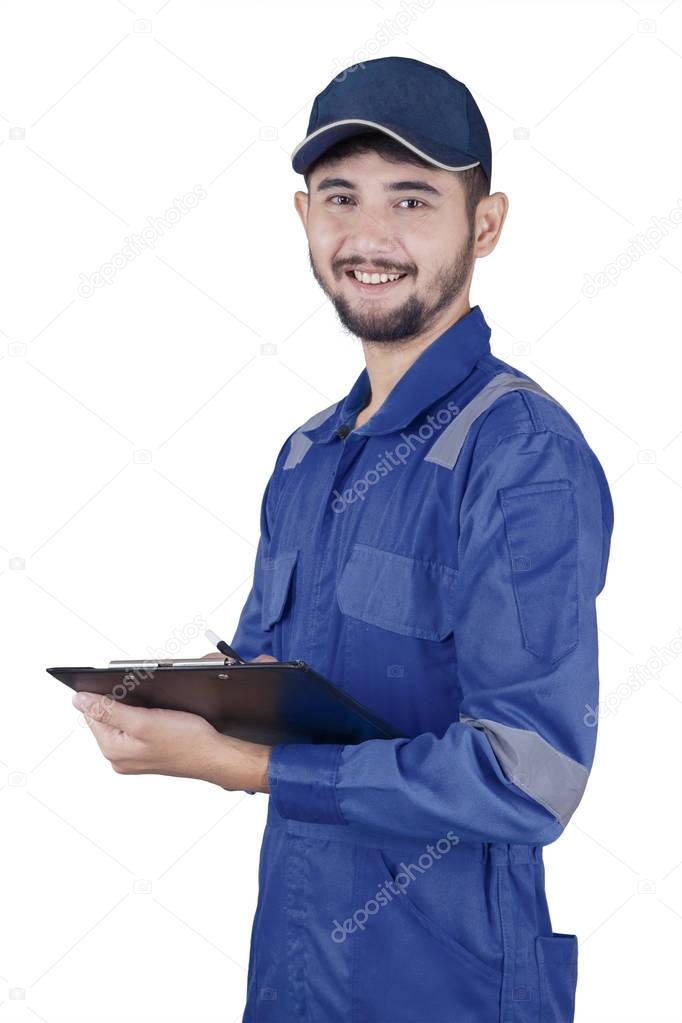 Young mechanic holds clipboard 