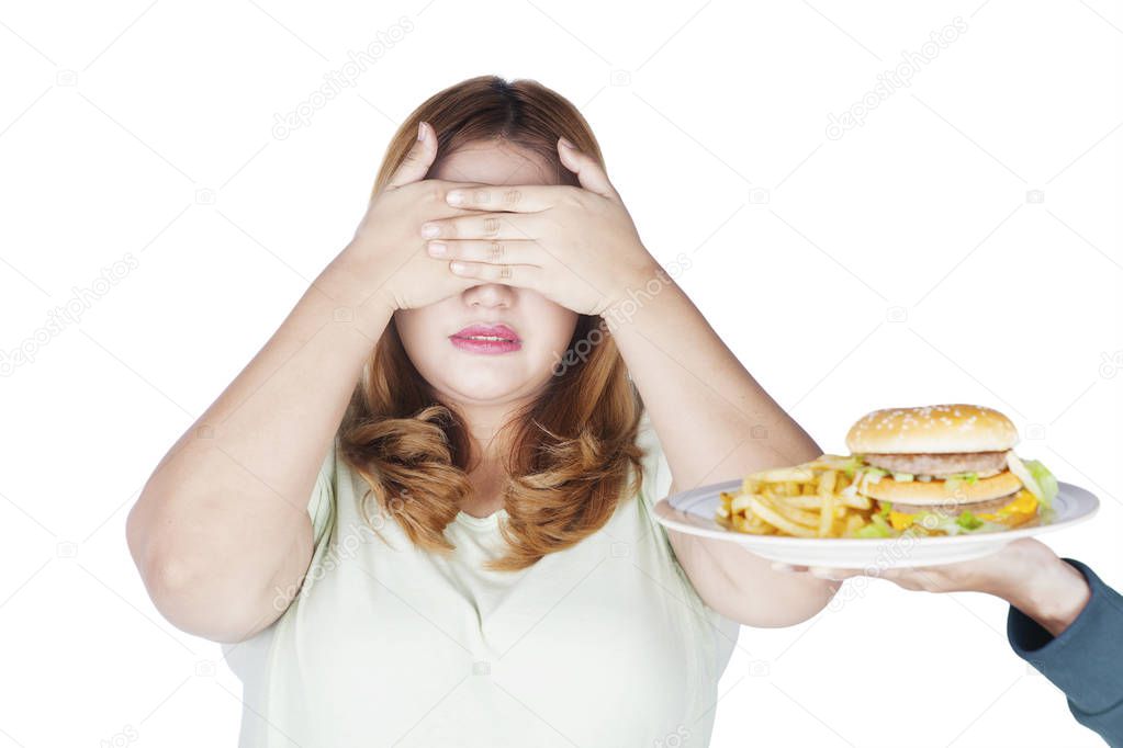 Overweight woman closing eyes 
