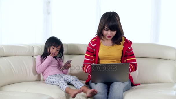 Child and mother using gadget — Stock Video