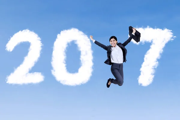 Cheerful businesswoman jumping with 2017 — Stock Photo, Image